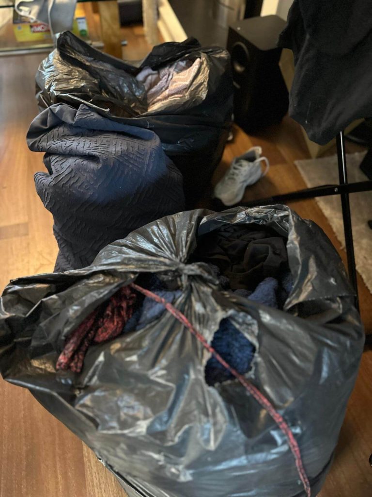 bin bags full of clothes and items during hoarder cleaning service